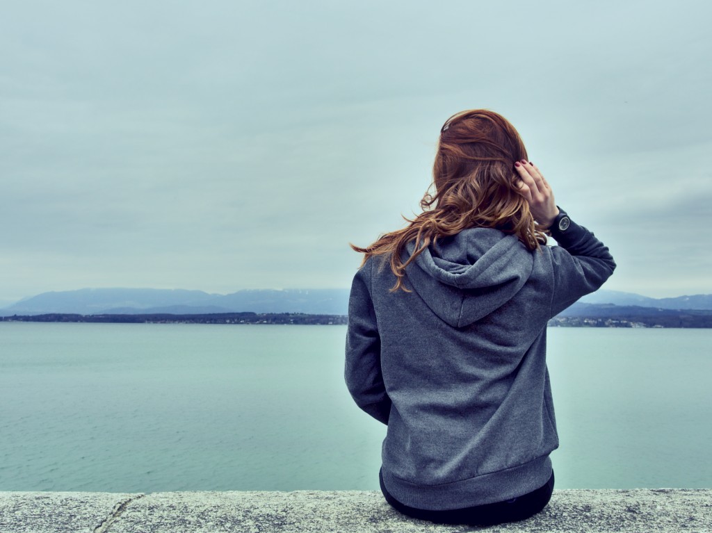 Woman Looks Over Bridge to Make Decision