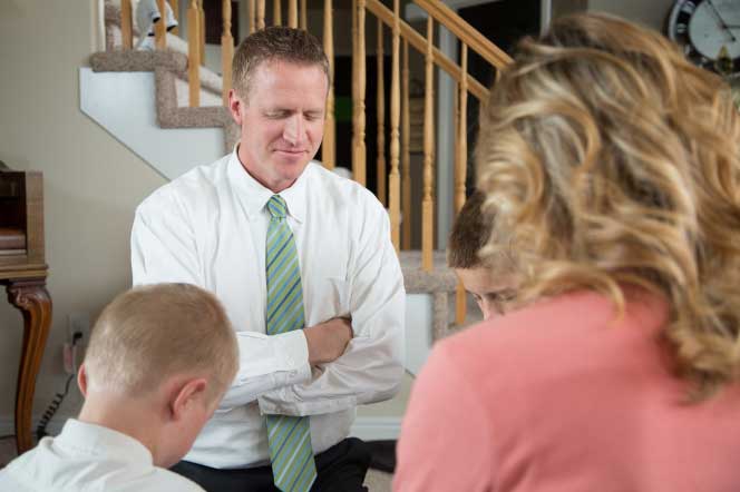 Family kneeling in prayer.