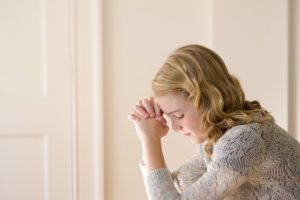 A young girl praying