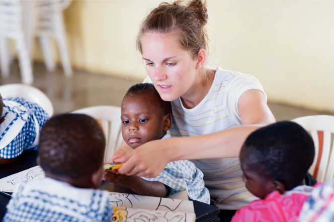 Woman serving children in Africa