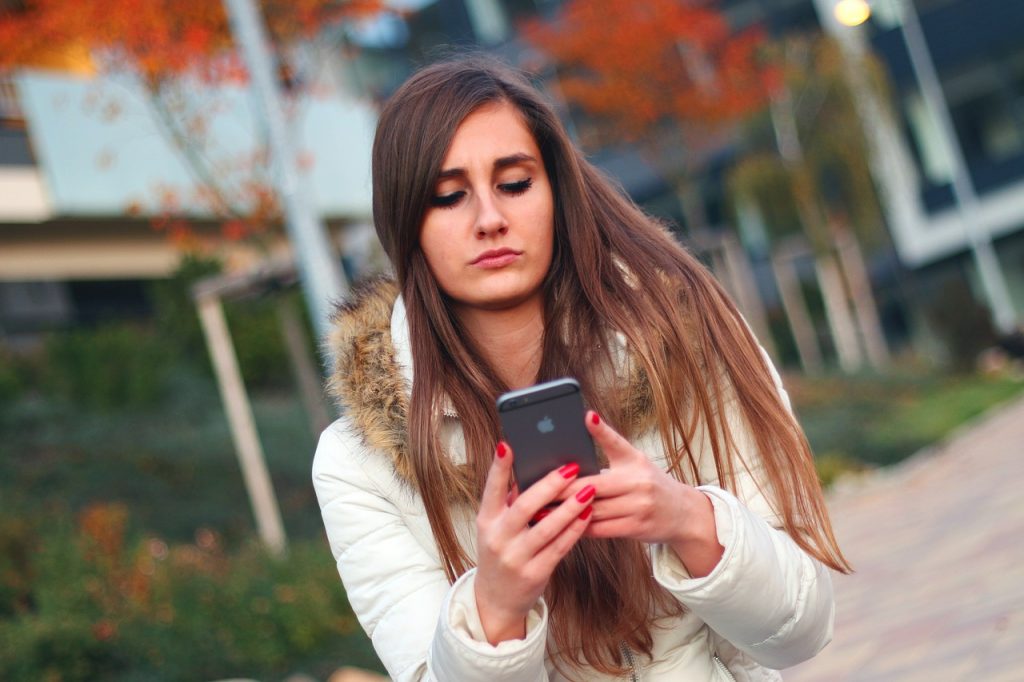 Woman Texting in Autumn