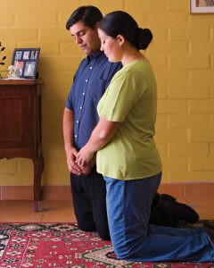 Couple kneeling in prayer together