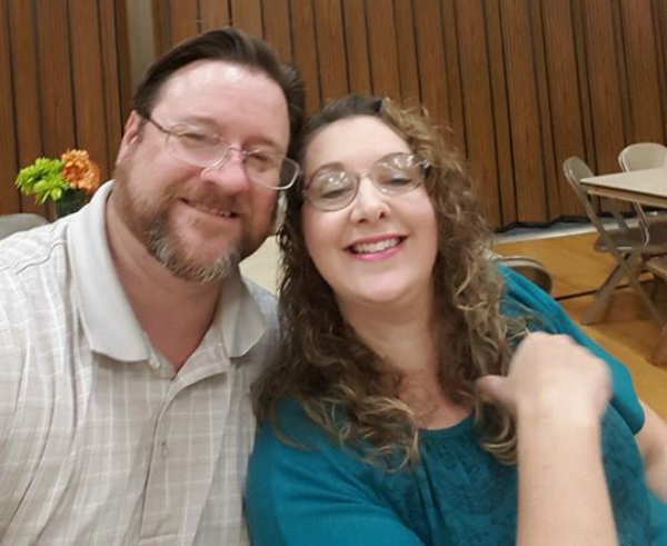 Happy couple sitting together in a church gym