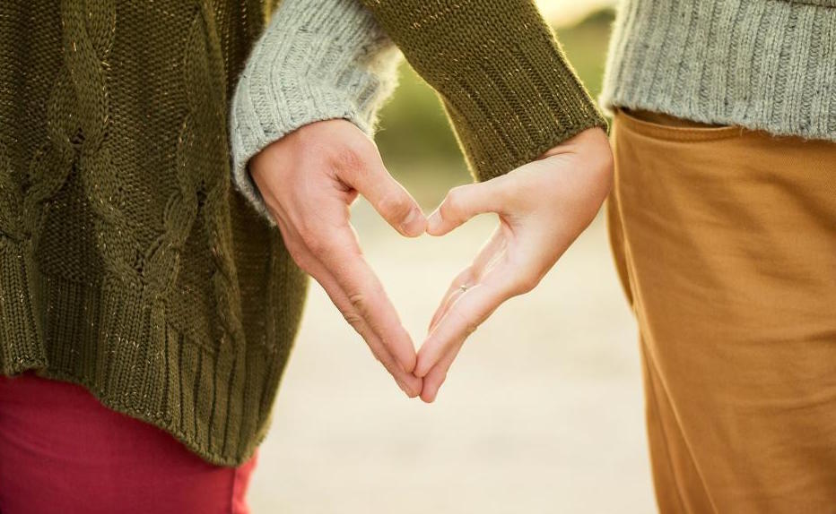 couple’s hands shape a heart