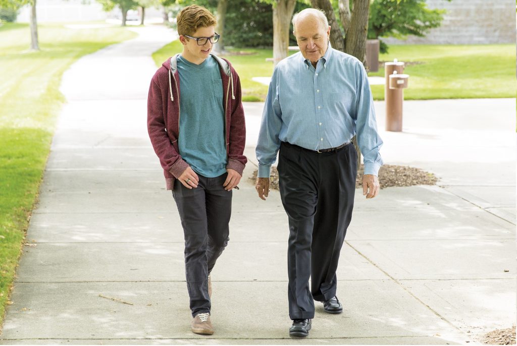 Old and young man walking together, speaking the tongue of angels