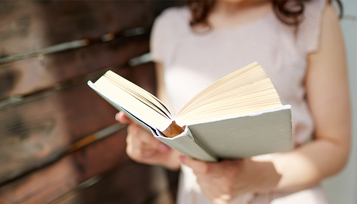 teen holds a great book