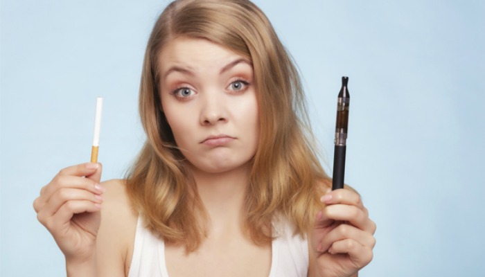 girl holding cigarette and e-cigarette