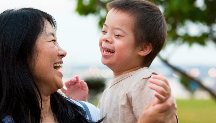 Asian mother holding son