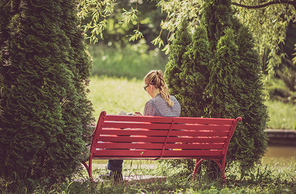 Woman reads scriptures outside