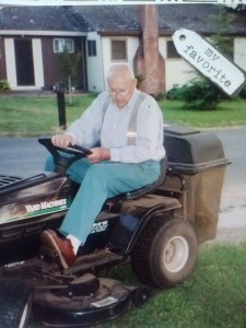 old man riding lawn mower