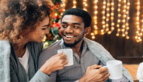 man and woman drinking hot chocolate at home