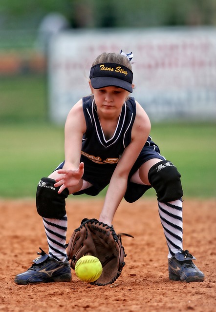 girl fielding softball