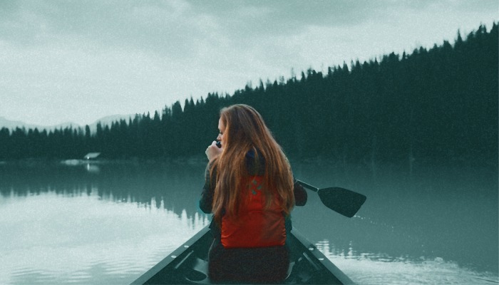 girl rowing on lake