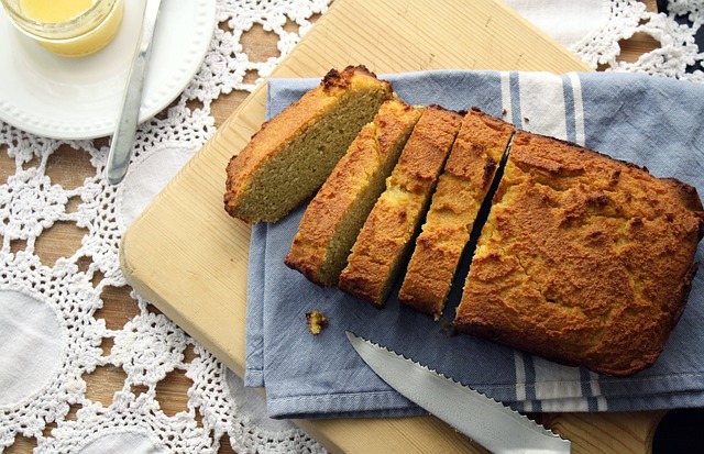 Loaf of gluten free bread on cutting board with knife