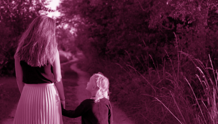 Mother walking with child sepia