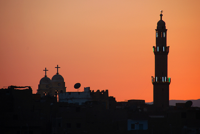 Islamic mosque and Christian church at sunset