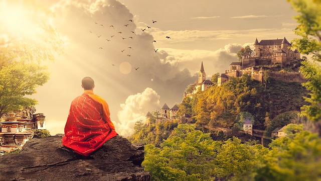 Monk on hill practicing Meditation castle in background