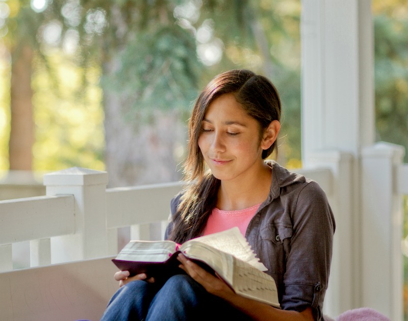 young woman reading Bible