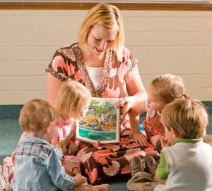 A female primary teacher teaches a sunbeam class.