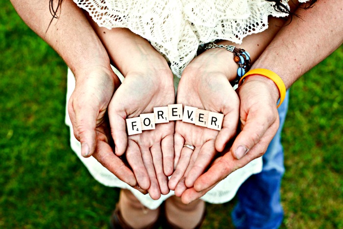 Couple Holding Hands and holding letters that spell forever