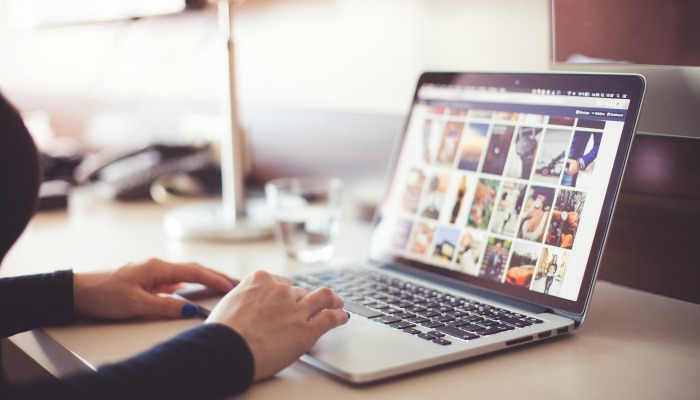 A woman uses social media on her laptop