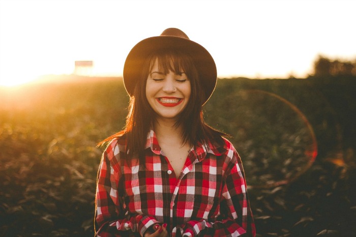 A woman in a plaid shirt smiling