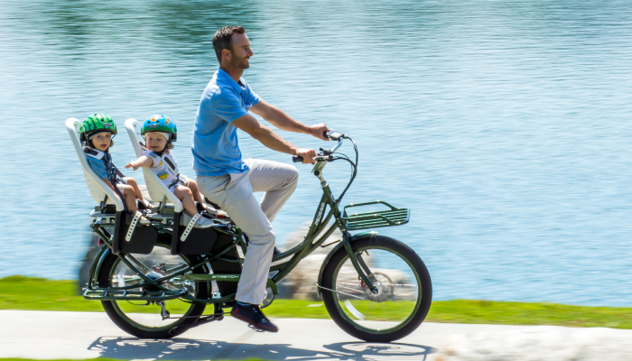 Dad on bike with kids