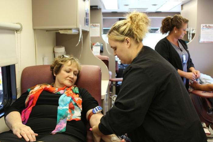 A woman donates blood