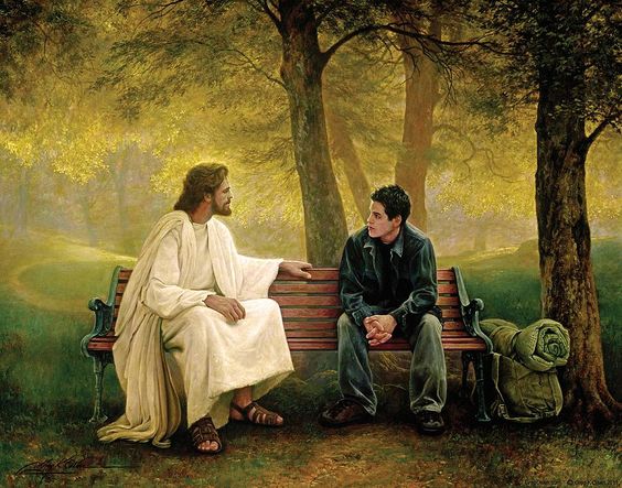 Christ talking with young man on park bench.