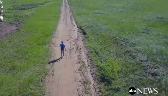 man walking on path aerial shot