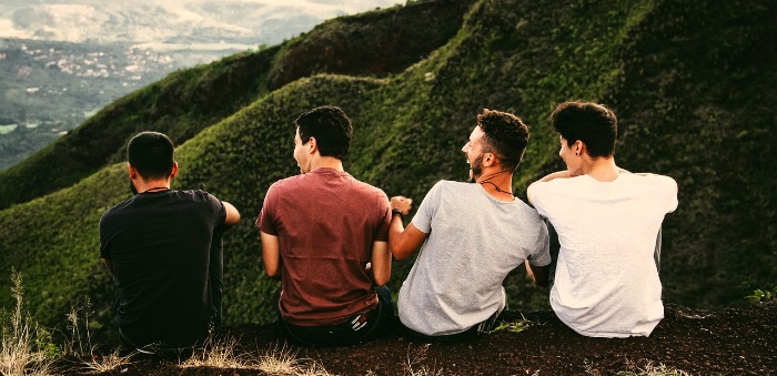 4 male friends sitting together