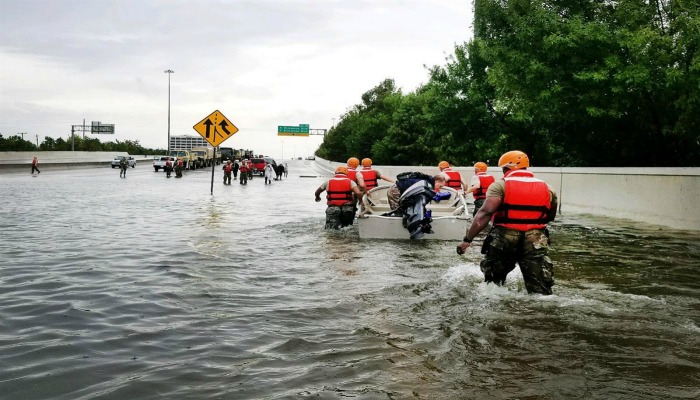 National Guard wade through flooded streets