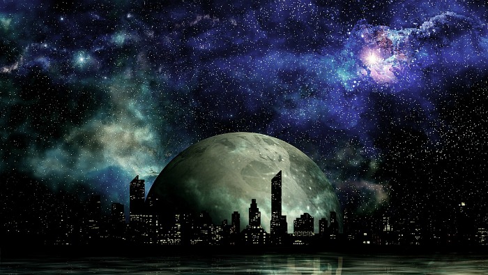 A Science Fiction Cityscape silhouetted against a moon