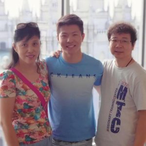 A photo of ChenWei, center, and his parents, mom left, dad right, in front of the Salt Lake City LDS Temple