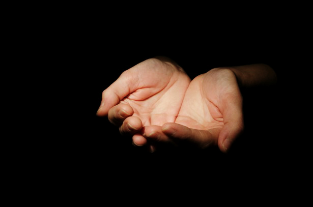 Person offering compassionate, outstretched hands