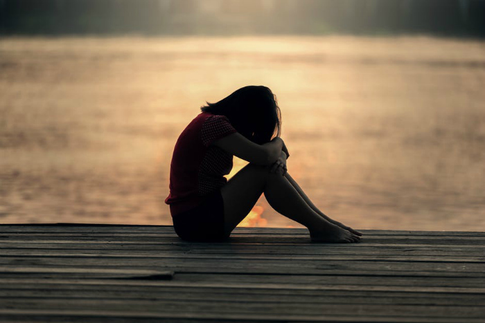 Photo of sad young woman by a lake New Young Women's Camp Guidebook