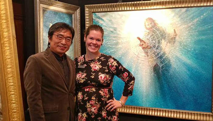 Katie Garner and Yongsung Kim pose in front of Kim's large-scale painting entitles 