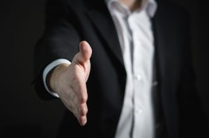 Man in suit extending hand in greeting