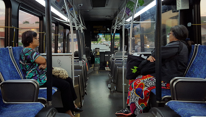 Two women not speaking on a bus