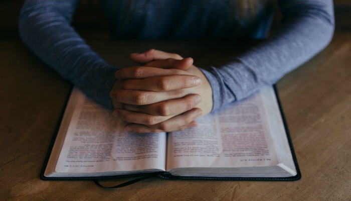 Man praying over scriptures