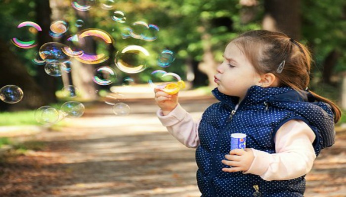 girl blowing bubbles