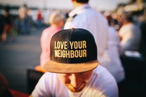 Man wearing cap that says love your neighbor charity