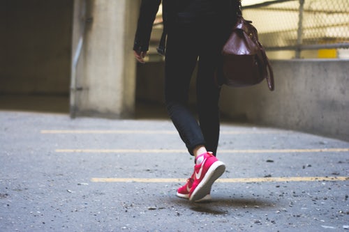 Person walking away from the camera with Nike shoes on