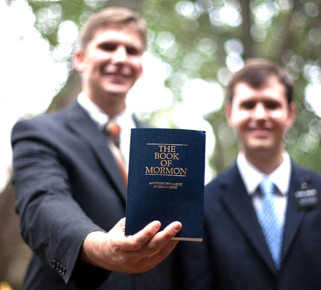 Missionaries teach with the Book of Mormon