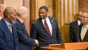 Derrick Johnson and President Nelson shaking hands 