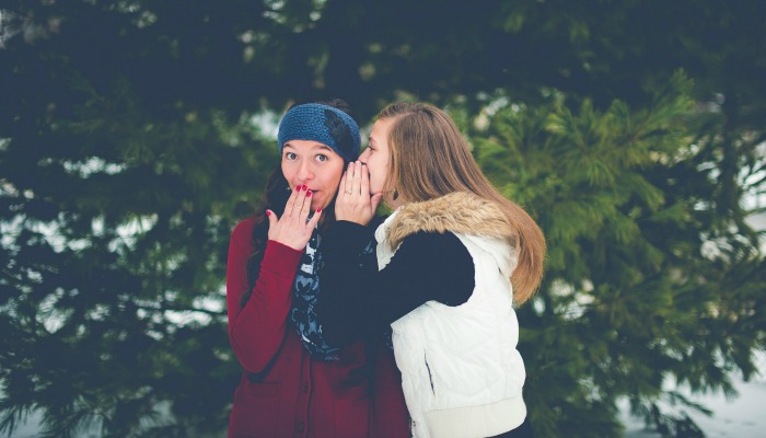Two young women gossiping