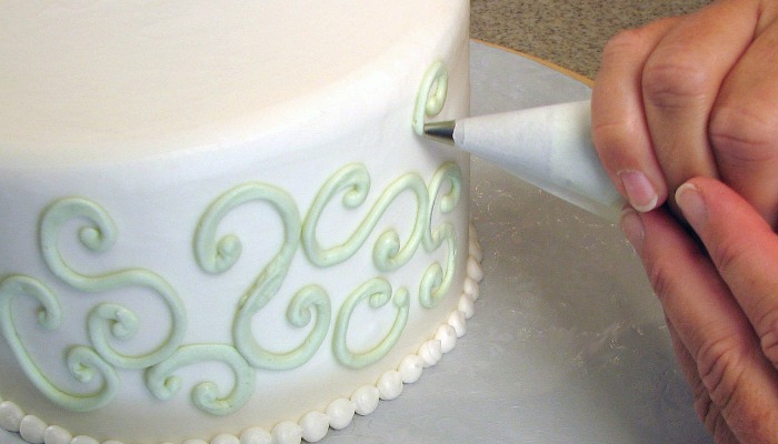 decorating a wedding cake