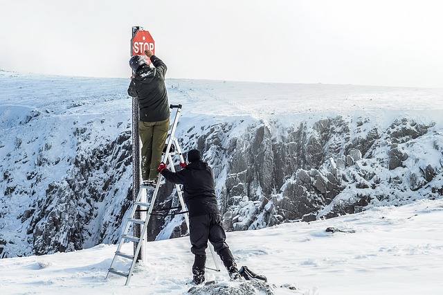 Mountain cliff with stop sign