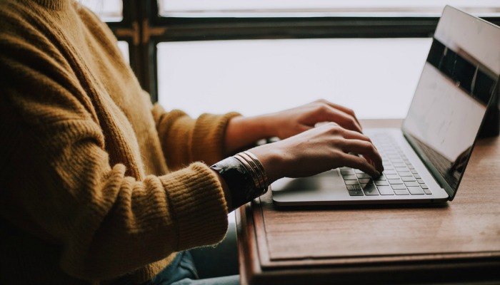 Woman typing on computer.