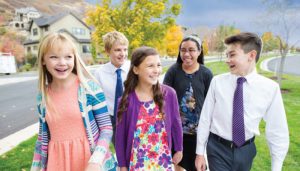 lds youth walking down the street in a group.